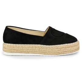 Sorte espadriller på platformen