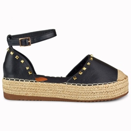 Sorte espadriller med nitter fastgjort ved anklen