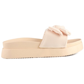 Beige dametøfler med sløjfe på en tyk sål