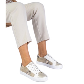 Gyldne sneakers med et dyremotiv dekoreret med glitter gylden