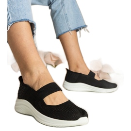 Sorte kvinders sneakers på en presset sål