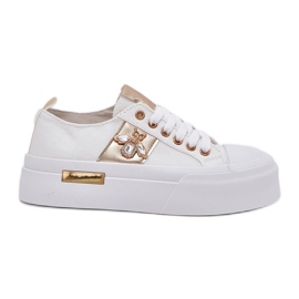 Kvinders sneakers på platformen med en dekorativ detalje hvid