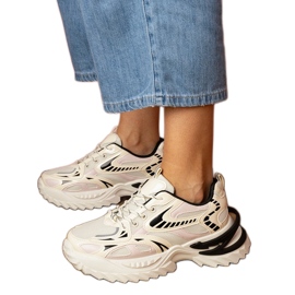 Beige sports -sneakers på en stilfuld sål