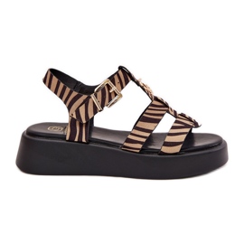 Kvinders sandaler på platformen med en gylden detalje af beige-sort zebra