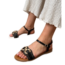Sorte flade sandaler med en gylden dekoration