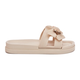 Kvinders flip flops med en bue og en gylden lys kogt broche beige