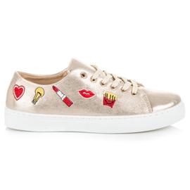 Gyldne sneakers med patcher gylden